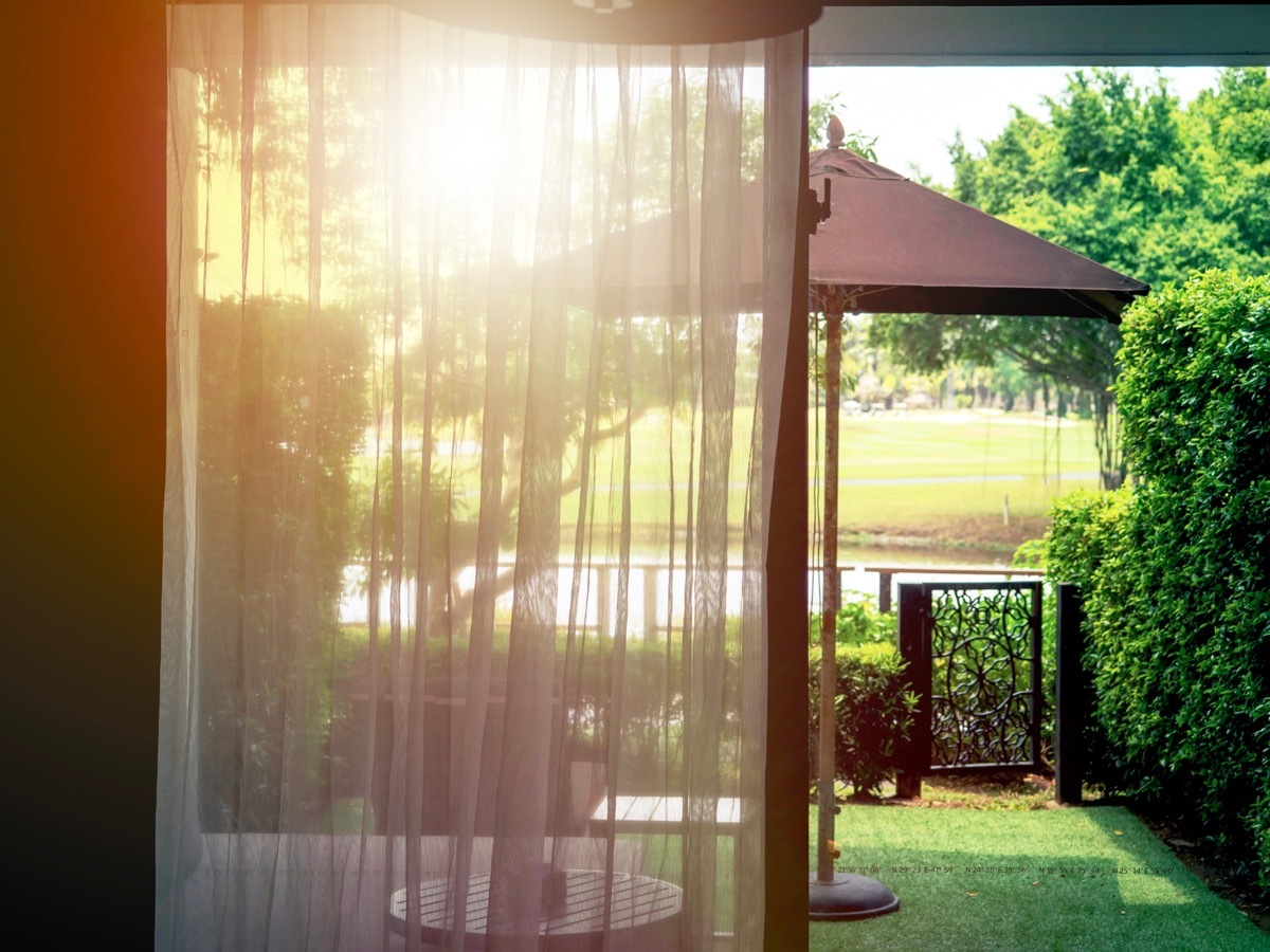 Sheer curtains on sliding glass door to yard