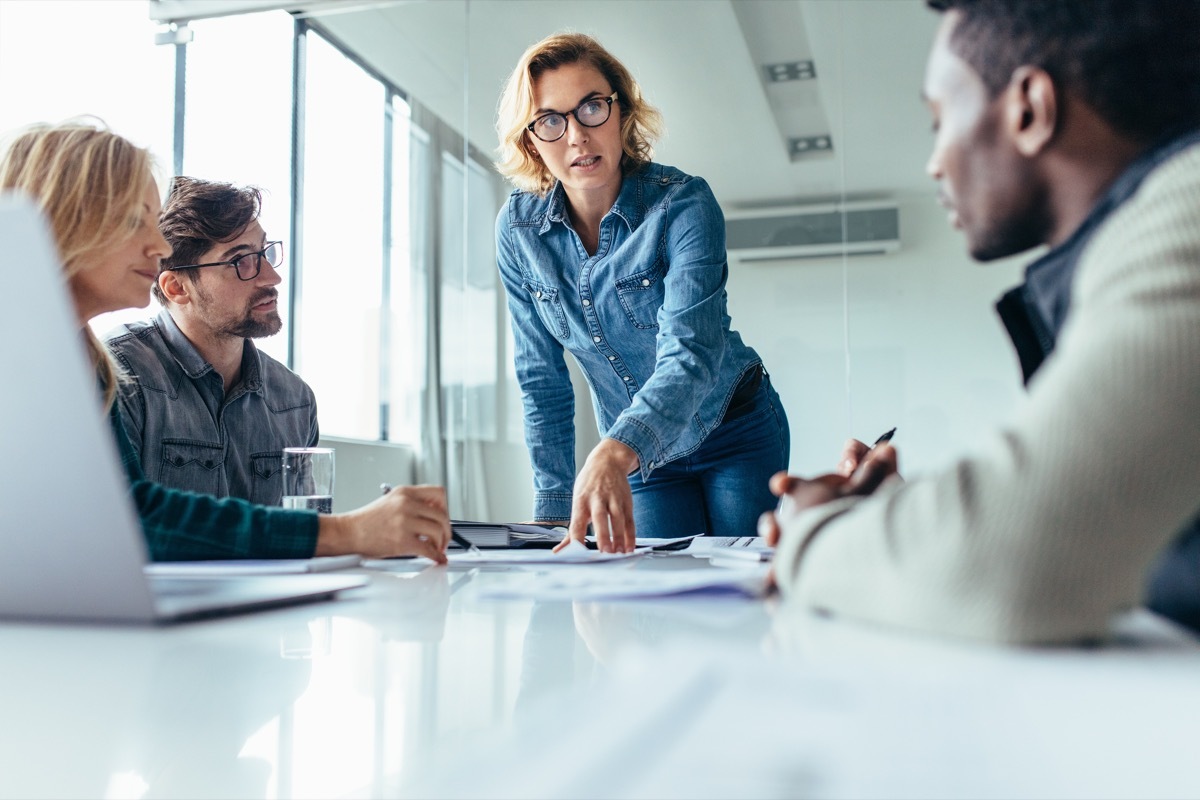 Female boss leads meeting of multiethnic staff