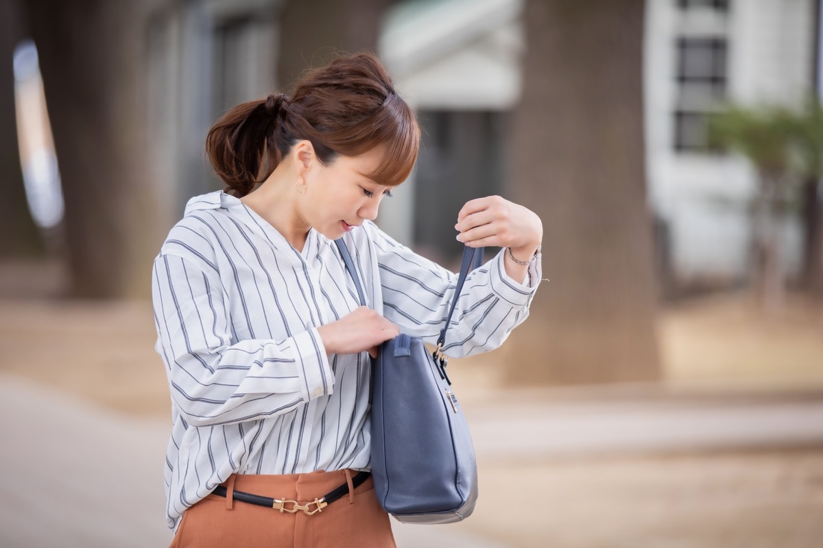 Women Looking for Something in Bag