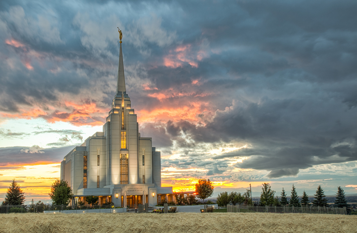 Wheat fields are almost ready to harvest near the Rexburg Idaho Temple at sunset.