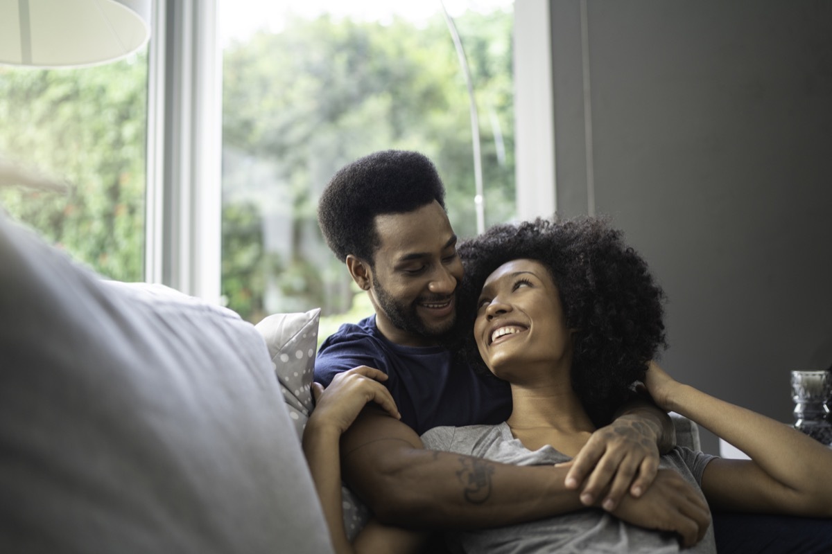 couple lying down and having romantic moment on couch