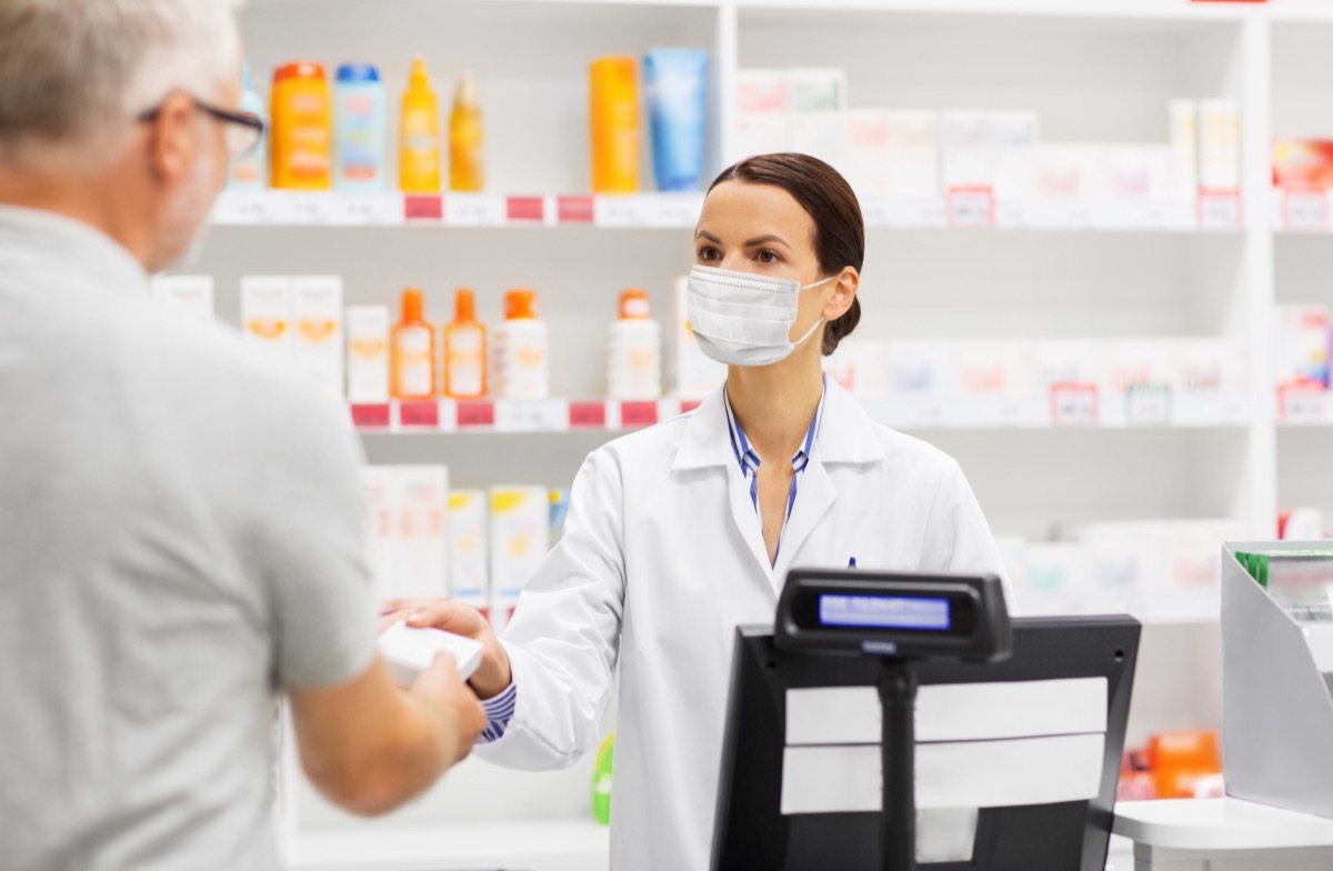 Man buying something from pharmacist with mask on