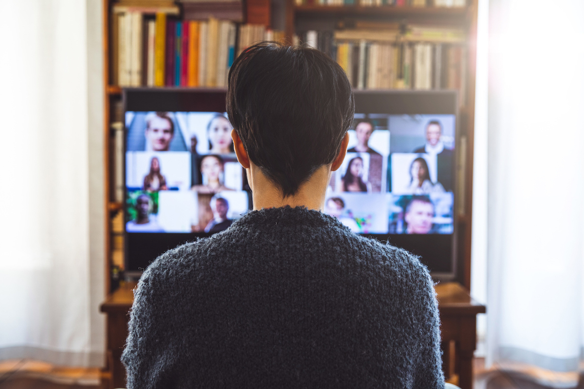 Woman in front of a screen doing a video conference 