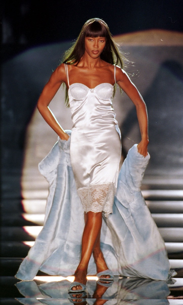 naomi campbell models in white slip dress, an example of a '90s fashion trend