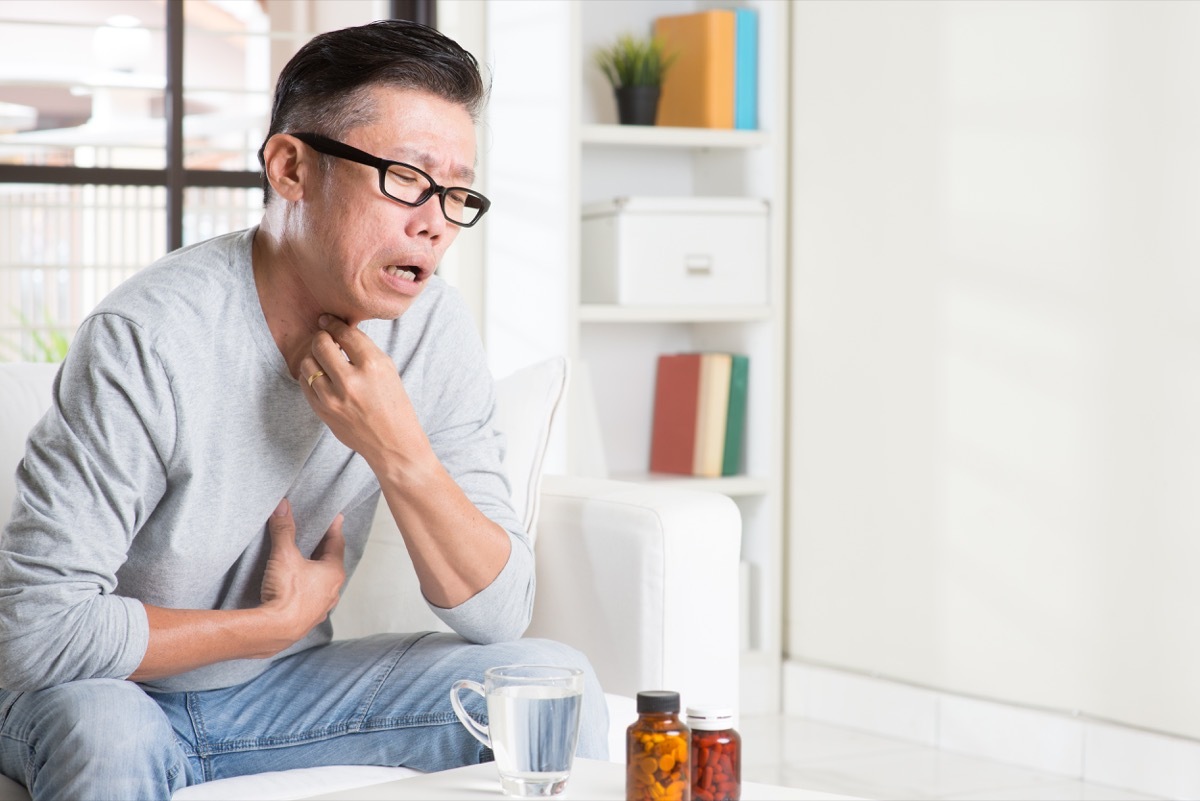 Older man struggling to swallow