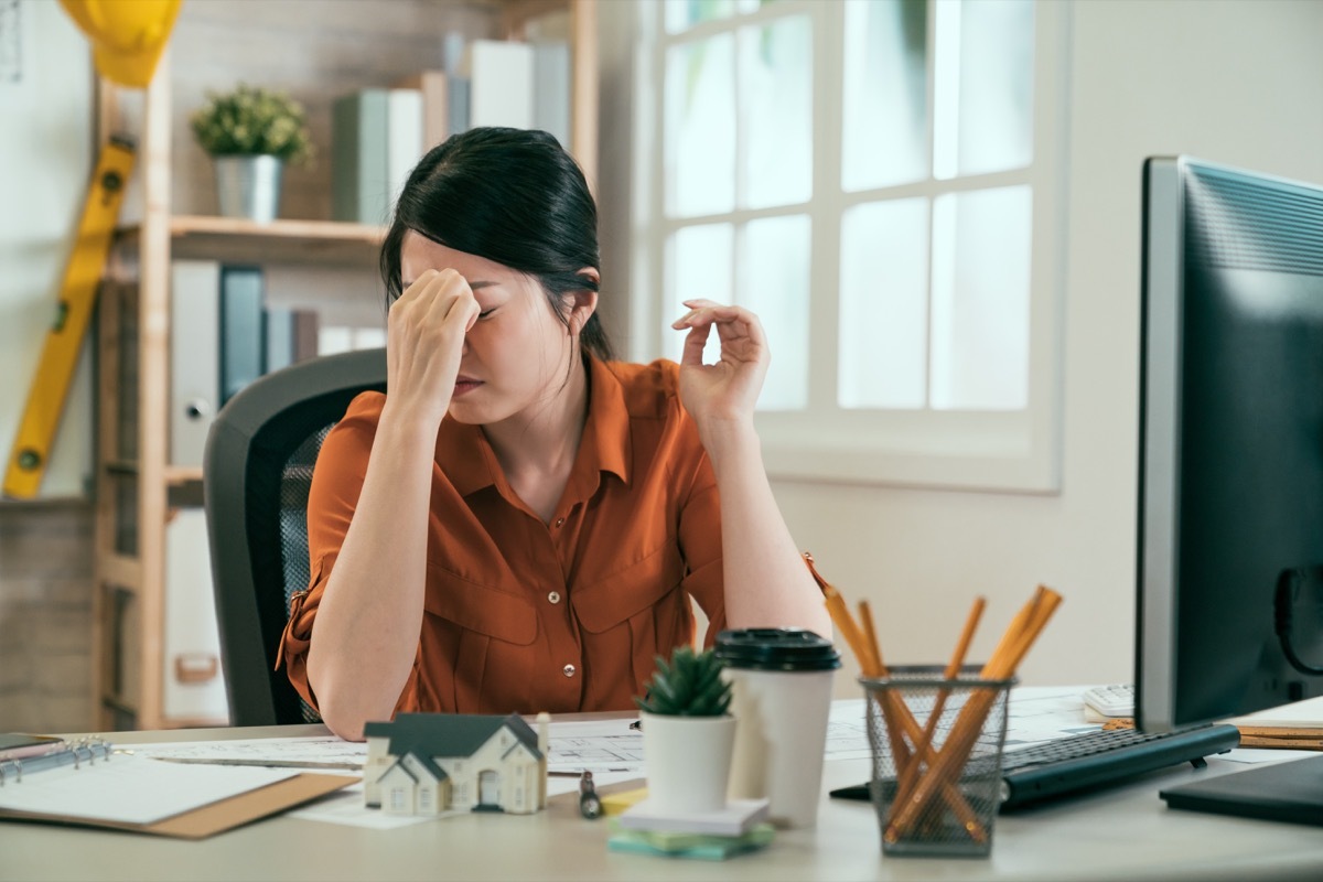 an interior decorator sitting at their desk annoyed