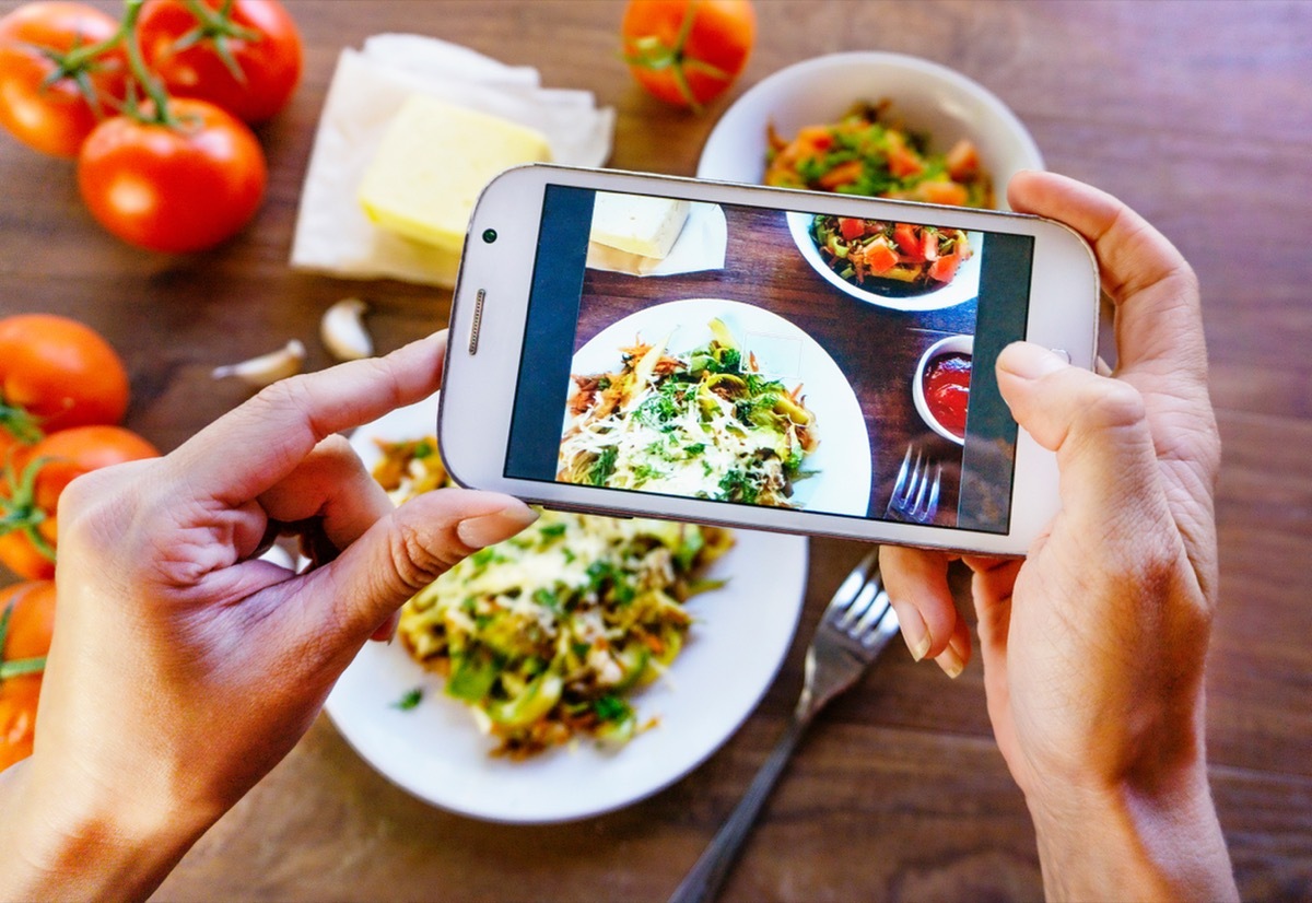 woman taking a photo of her meal for social media