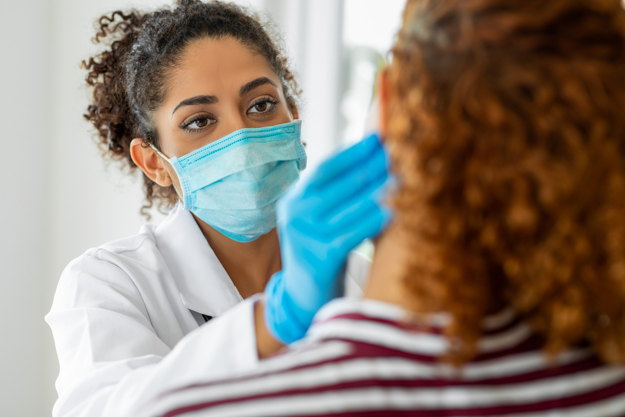 Doctor checking patient's jaw.