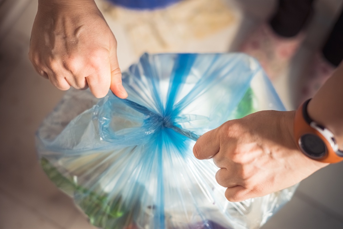 tied up blue trash bag ready to put to garbage