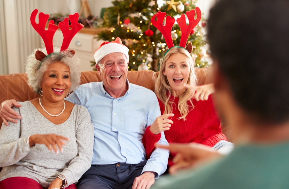 Group of friends wearing reindeer antlers and celebrating together