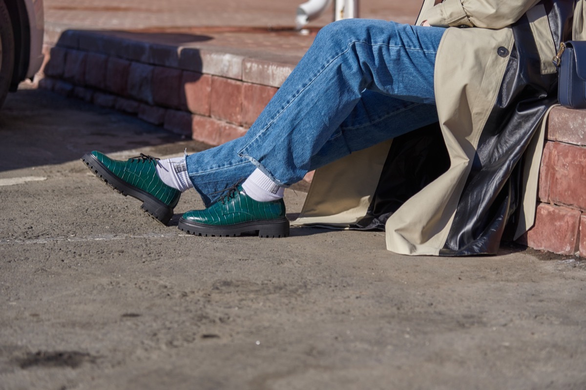 a woman sits outside in vintage clothing