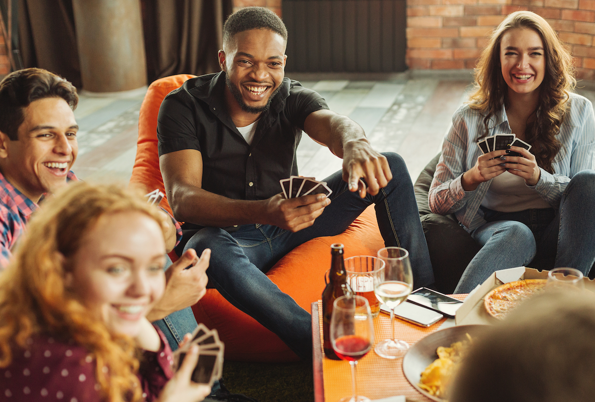 a group of people playing a card game