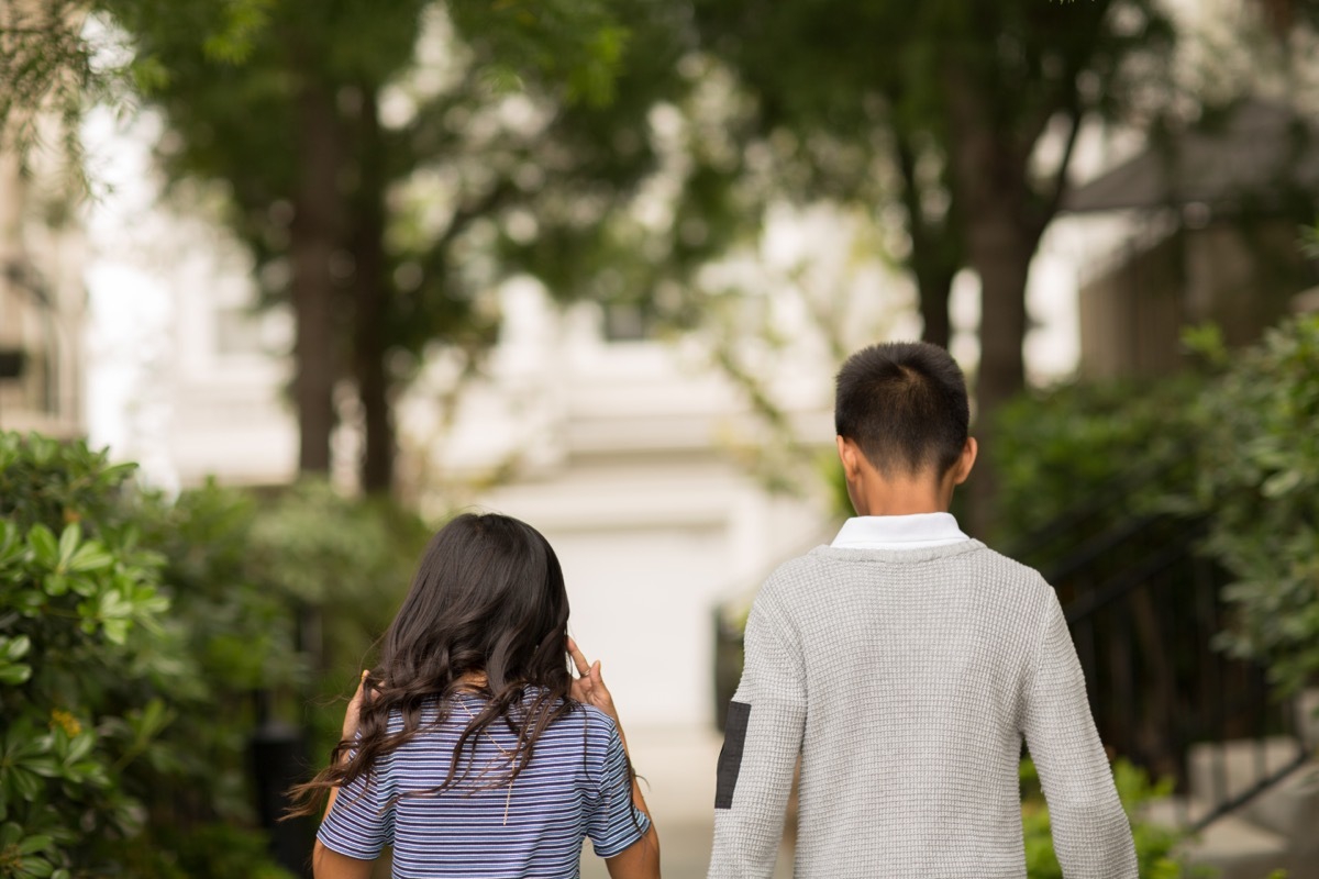 big brother walking down the street with his little sister