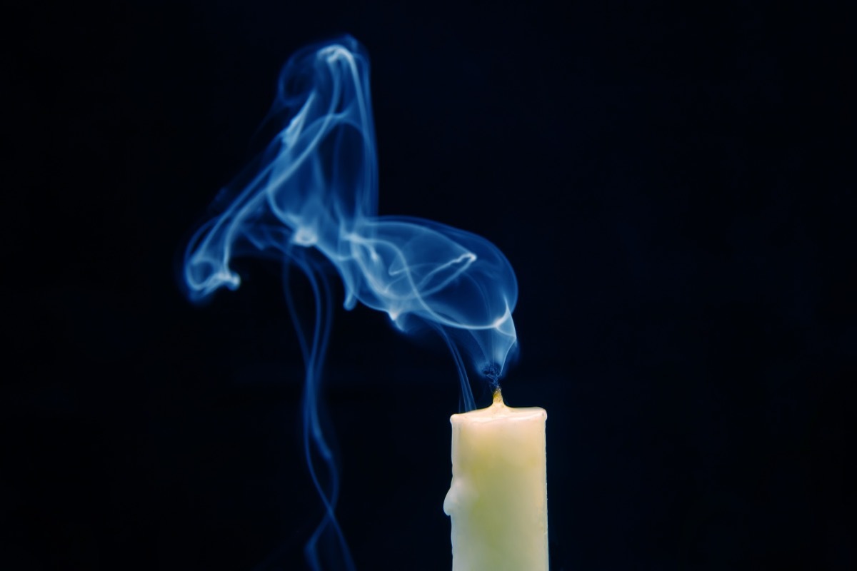 Smoke from an extinguished candle on a dark background