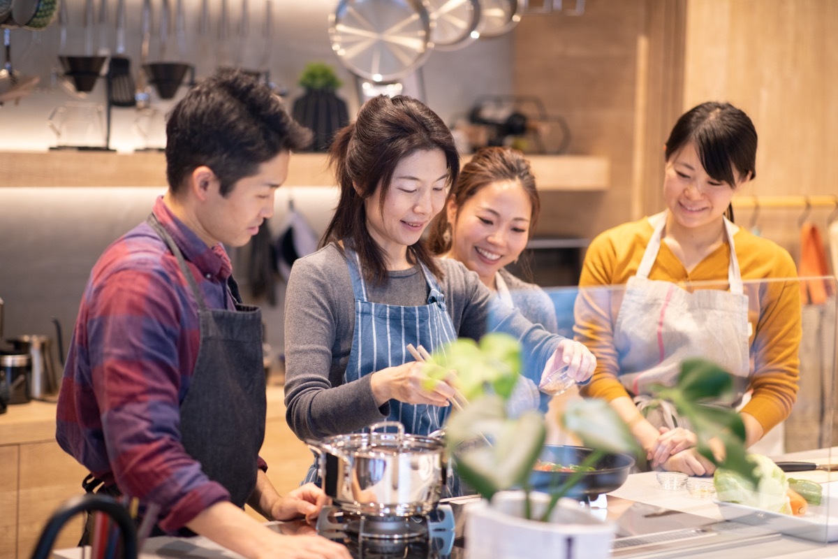 couple taking a cooking class with other people