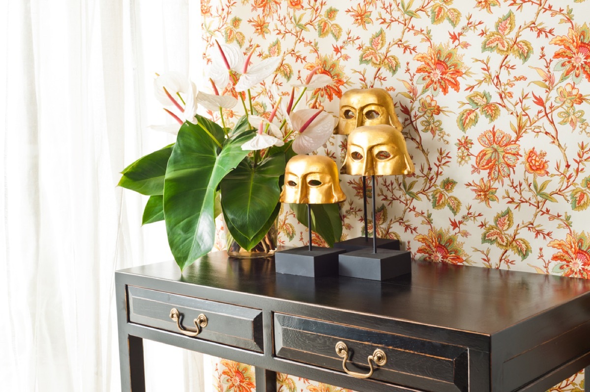 entryway wall with orange floral wallpaper