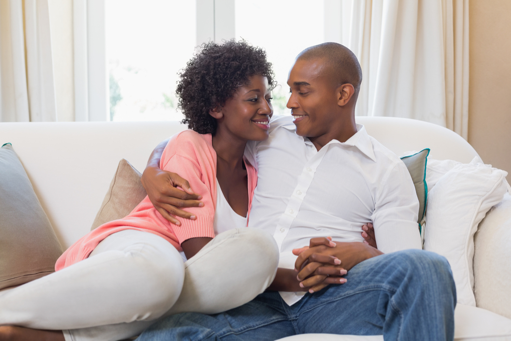 Couple Holding Hands on Couch Romance