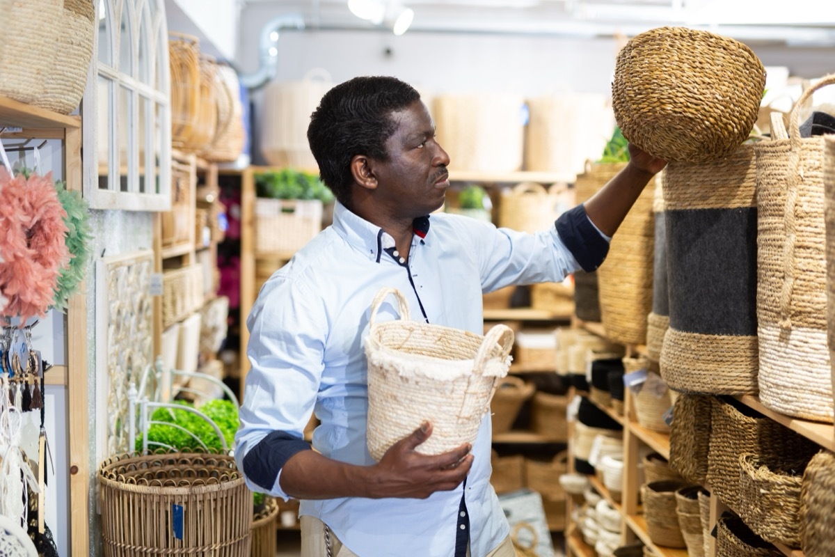 Man shopping for baskets at HomeGoods store. 