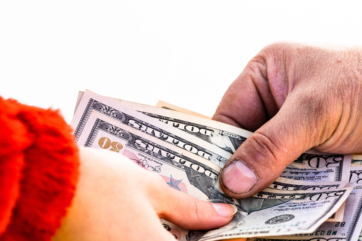 Hand giving money isolated, hard worked hand taking dollars money. Currency transfer on white background.