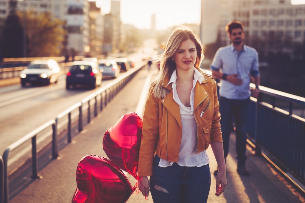 woman holding heart balloons, should i be single