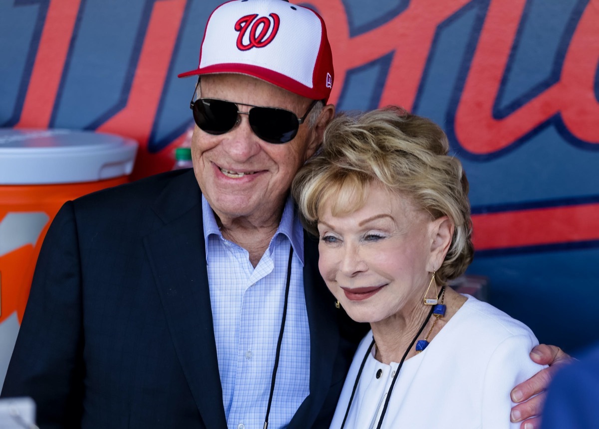 Nationals owner Ted Lerner hugs his wife Annette in the dugout during the opening day of Spring Training for the Washington Nationals and Houston Astros at the Ballpark of the Palm Beaches in West Palm Beach on February 28, 2017. 