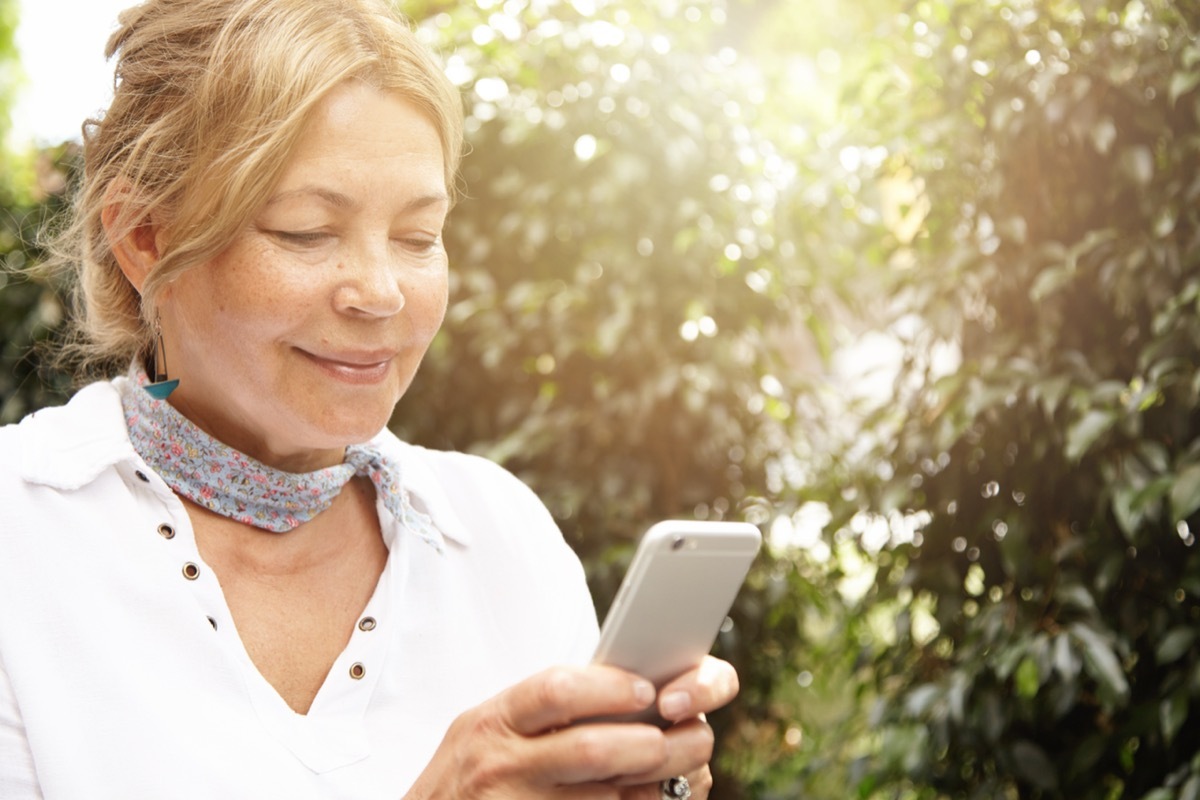 woman using smartphone in garden