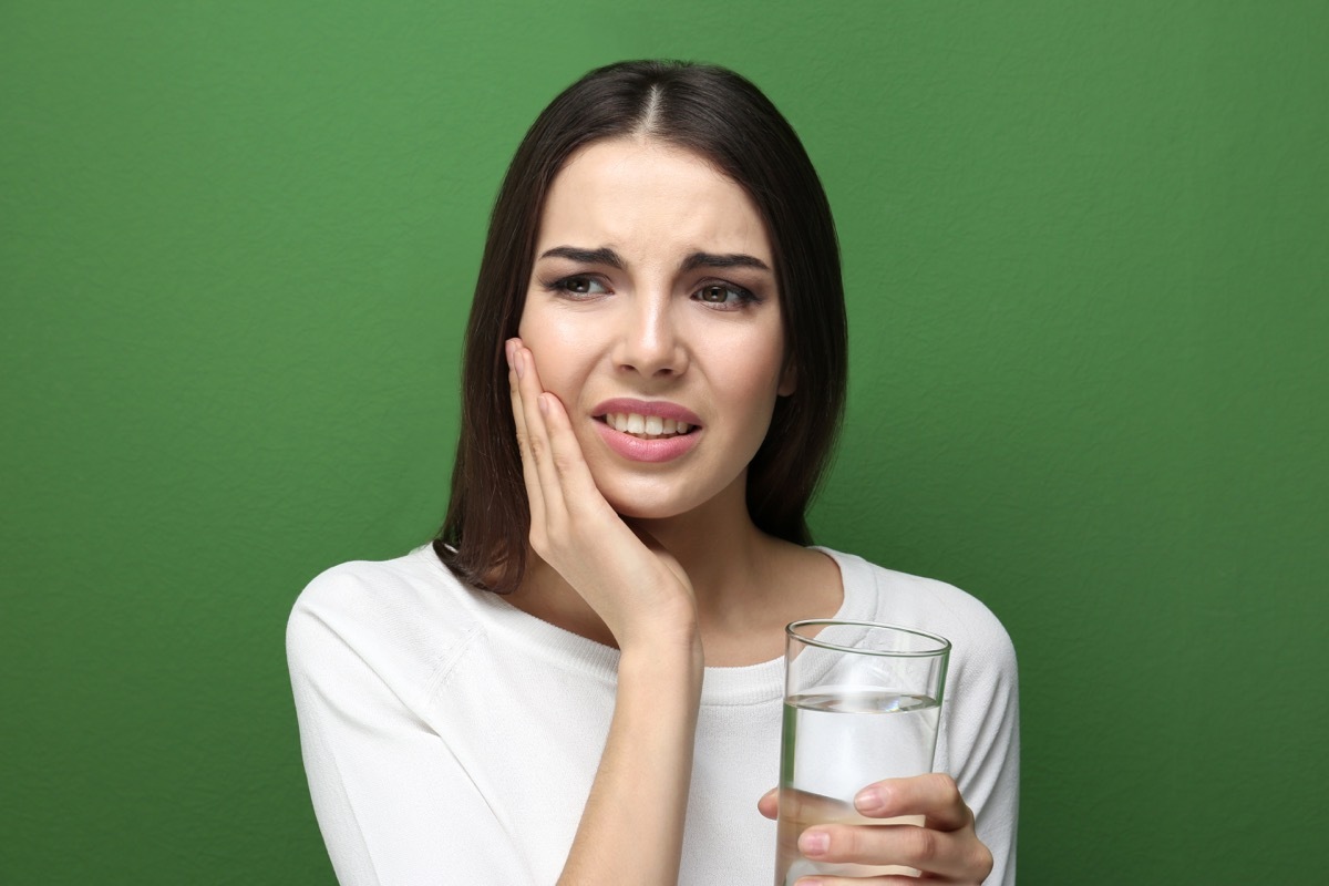 woman with medicine suffering from toothache