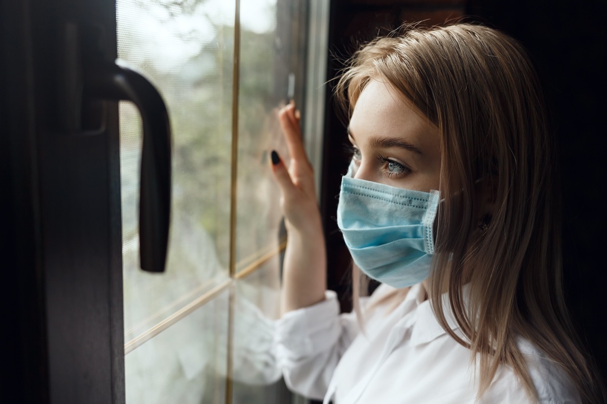 Woman home isolation quarantine wearing face mask