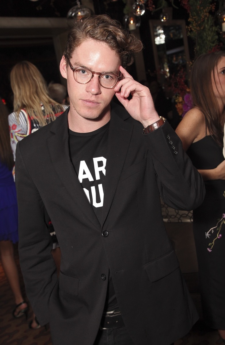 Tyler Clinton wearing glasses and black jacket