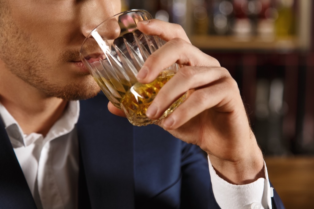 A man drinking whiskey, first heart attack