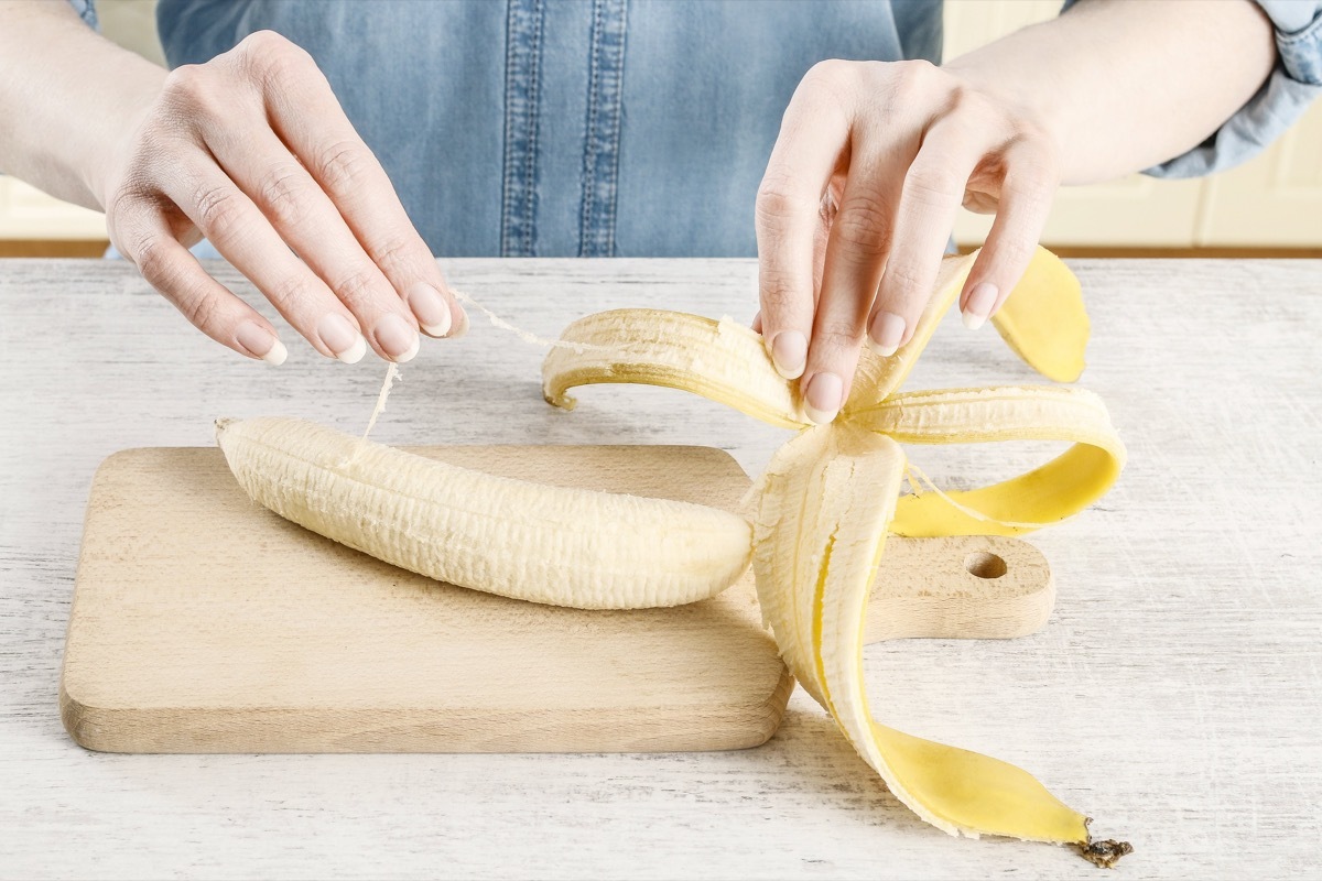 woman peeling banana with phloem bundles