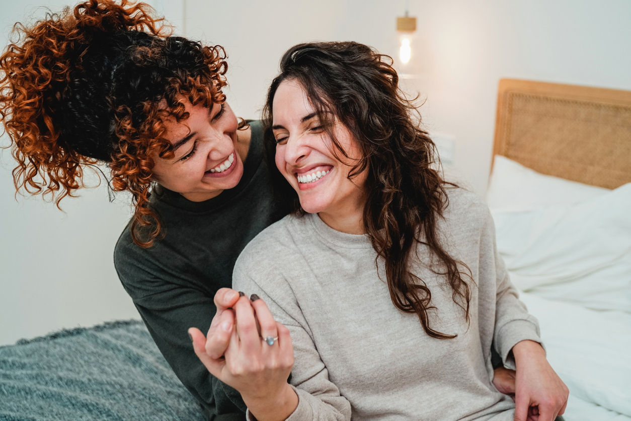 Two women laughing and embracing