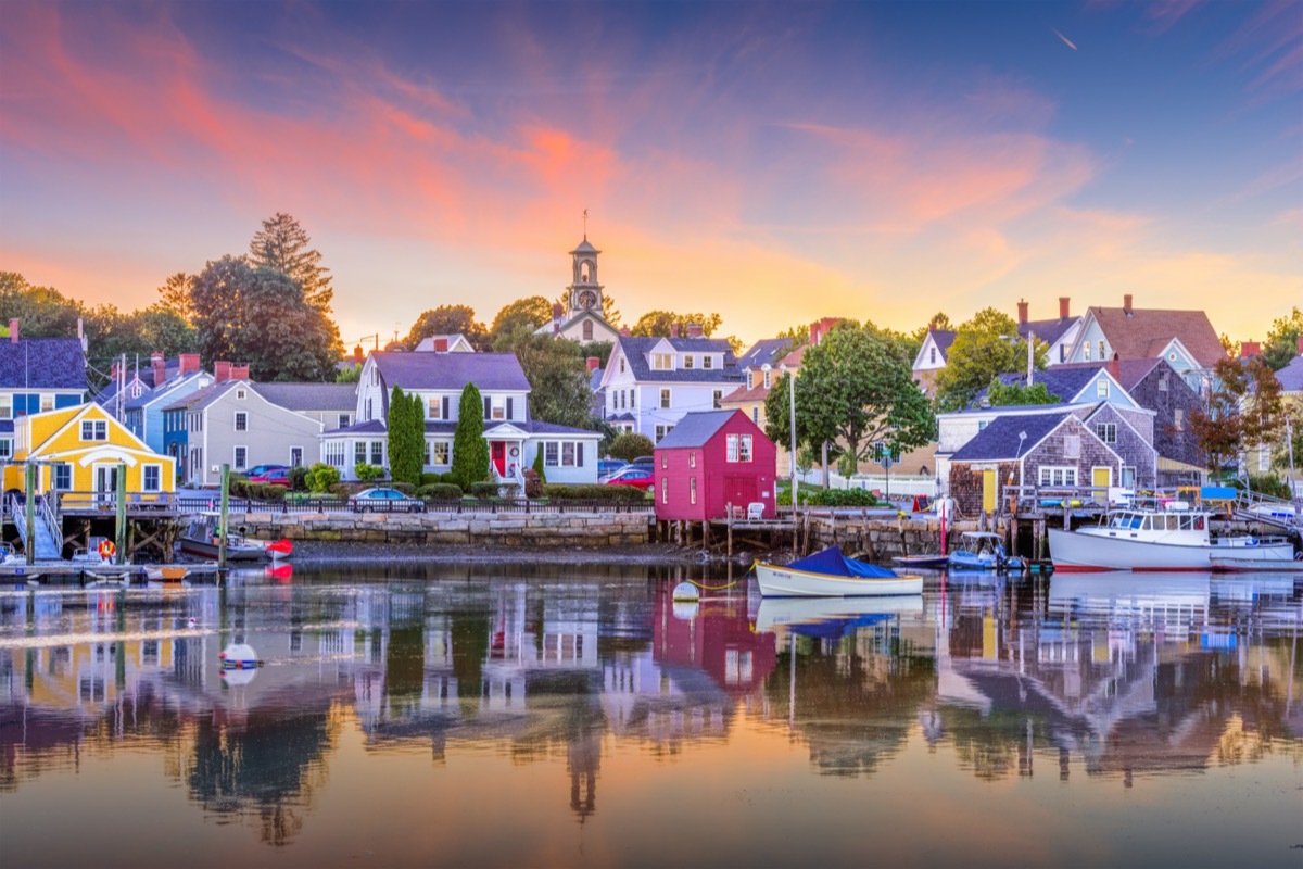 waterfront town with a harbor and boats at sunset