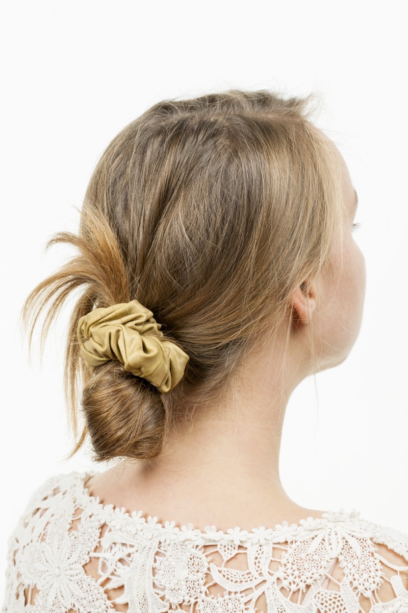 Blonde woman wearing a low messy bun with a scrunchie