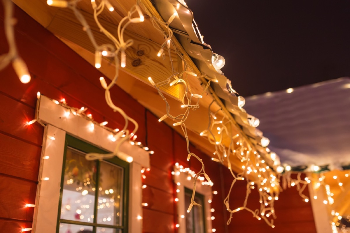 Close up on house decorated with white icicle lights