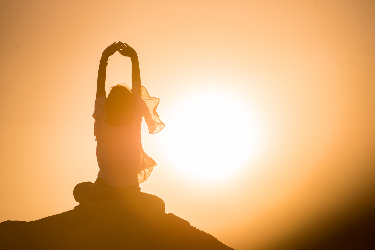 woman meditating in the sun