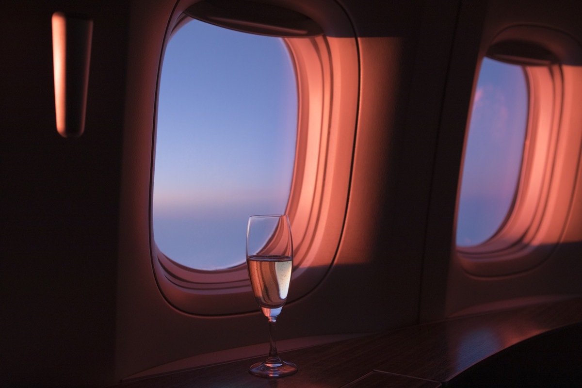 Glass of champagne in first class during sunset.