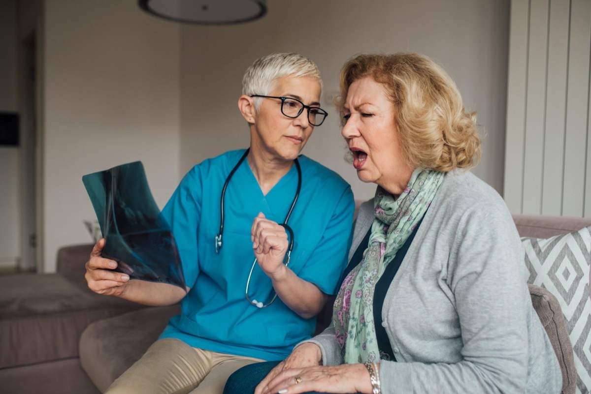 old woman looking at x-ray with doctor and asking questions