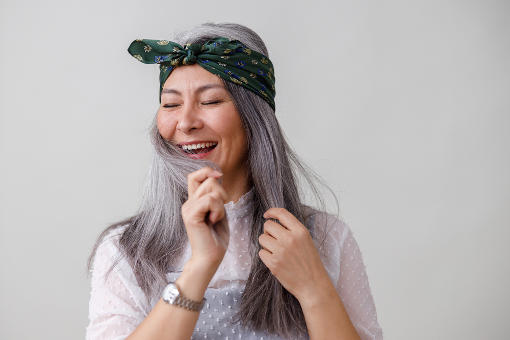 woman touching gray hair