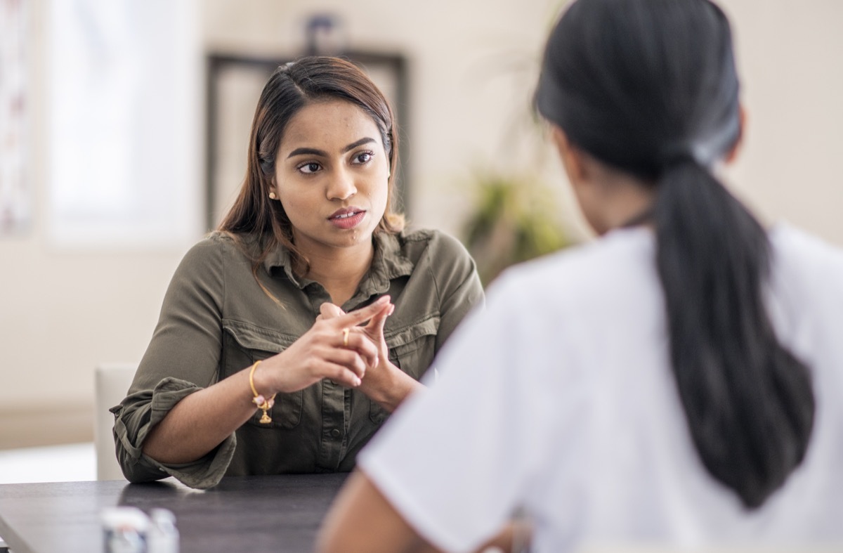 A frustrated woman is chatting with her mental health doctor. She is giving her some advice on how to deal with the complexities of life.