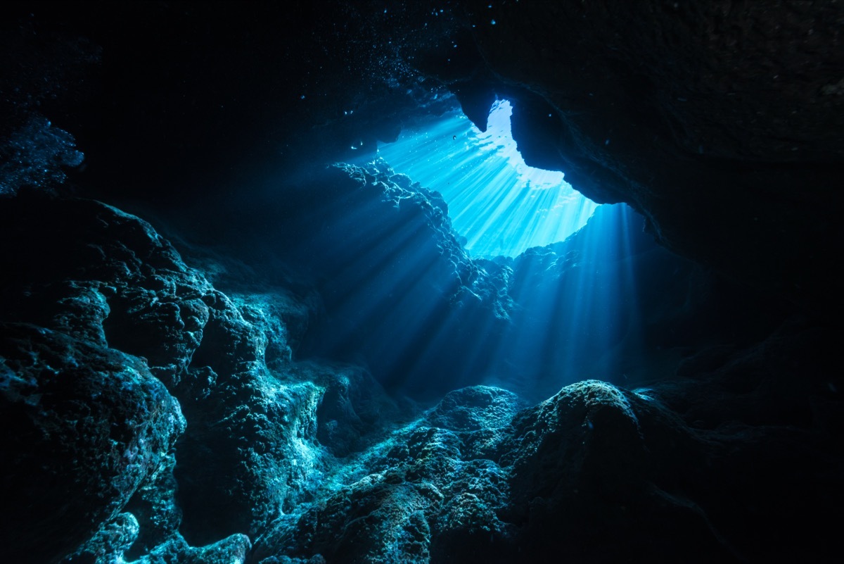 Rays of sunlight shining into the cave, underwater view