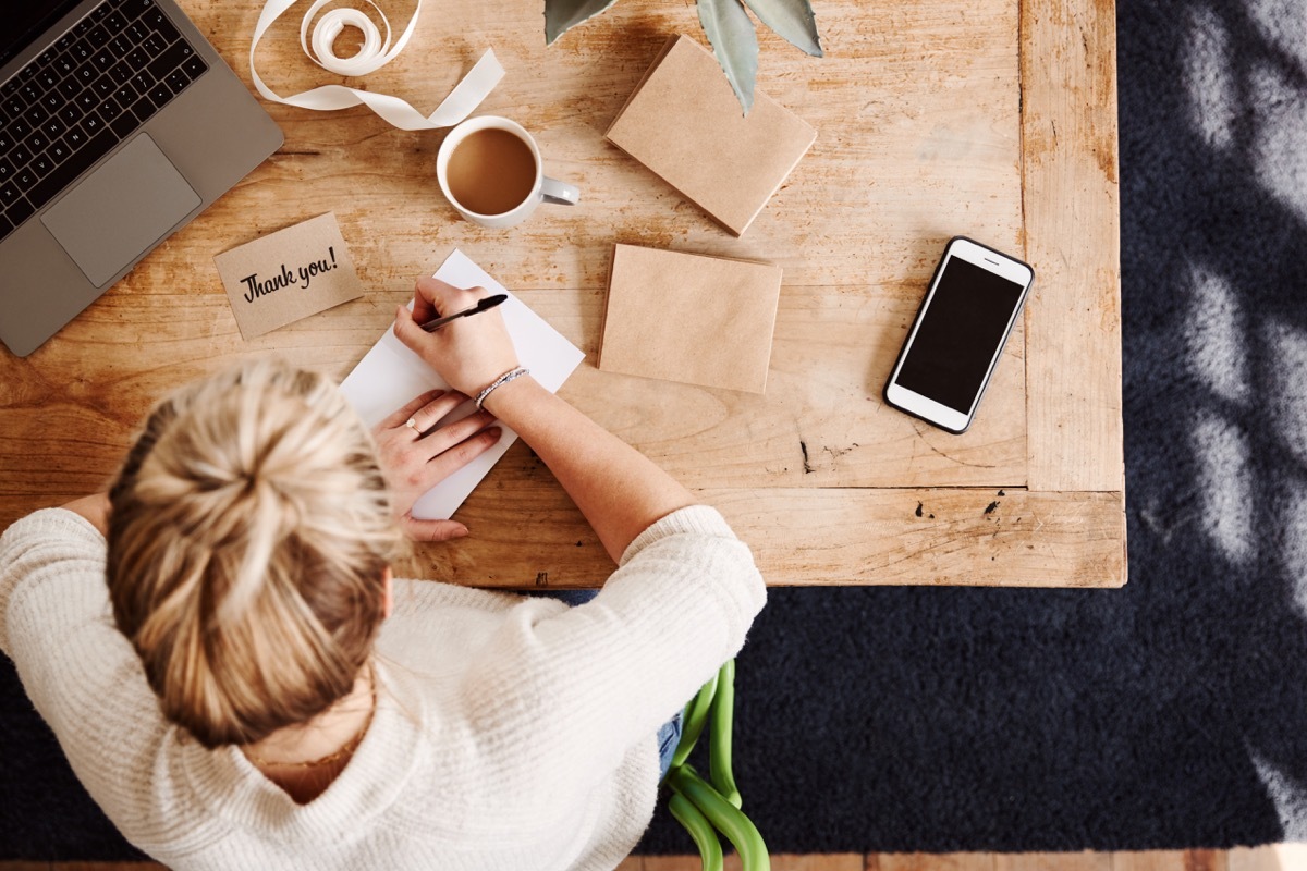 Woman writing a handwritten thank you letter