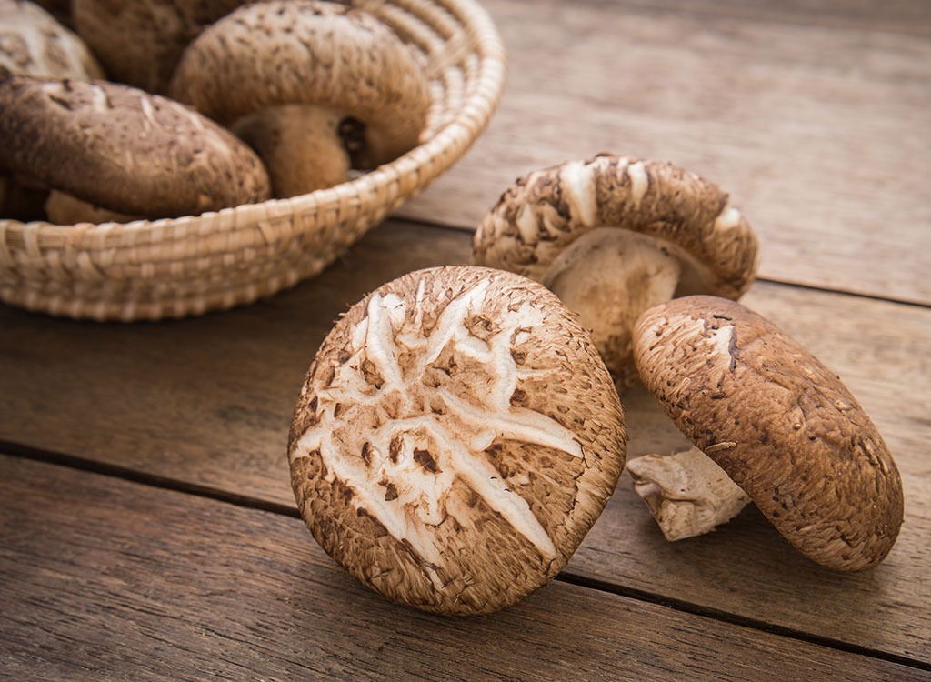 raw mushrooms on wood table