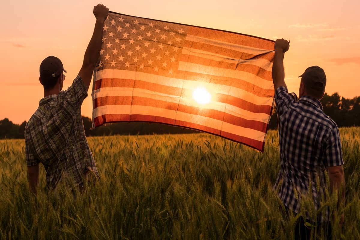 americans holding the flag on 4th of july