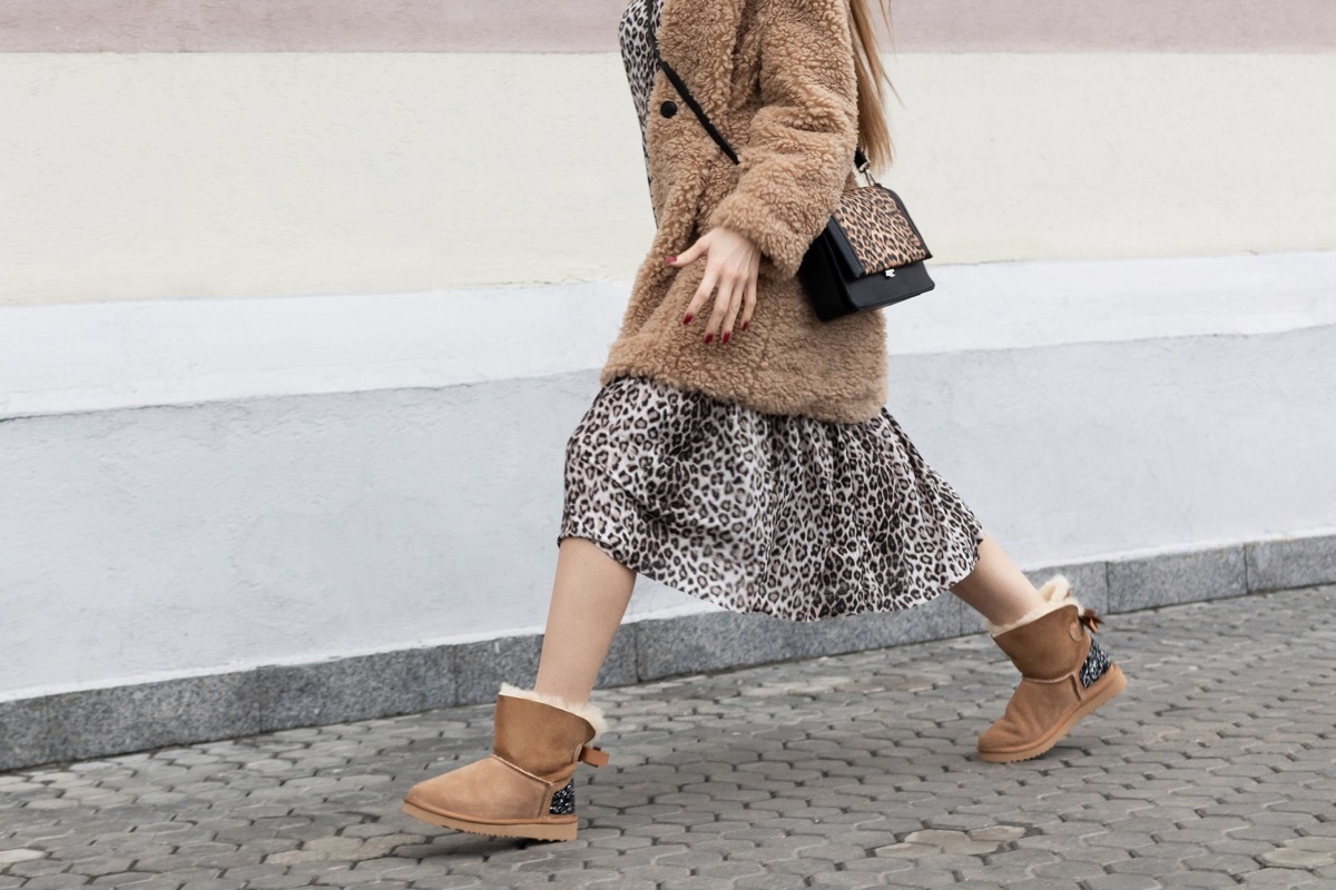 Woman walking wearing leopard print and uggs