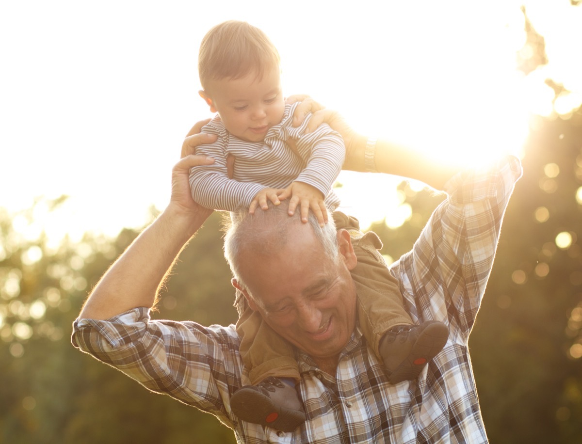 Grandfather with grandson on shoulders