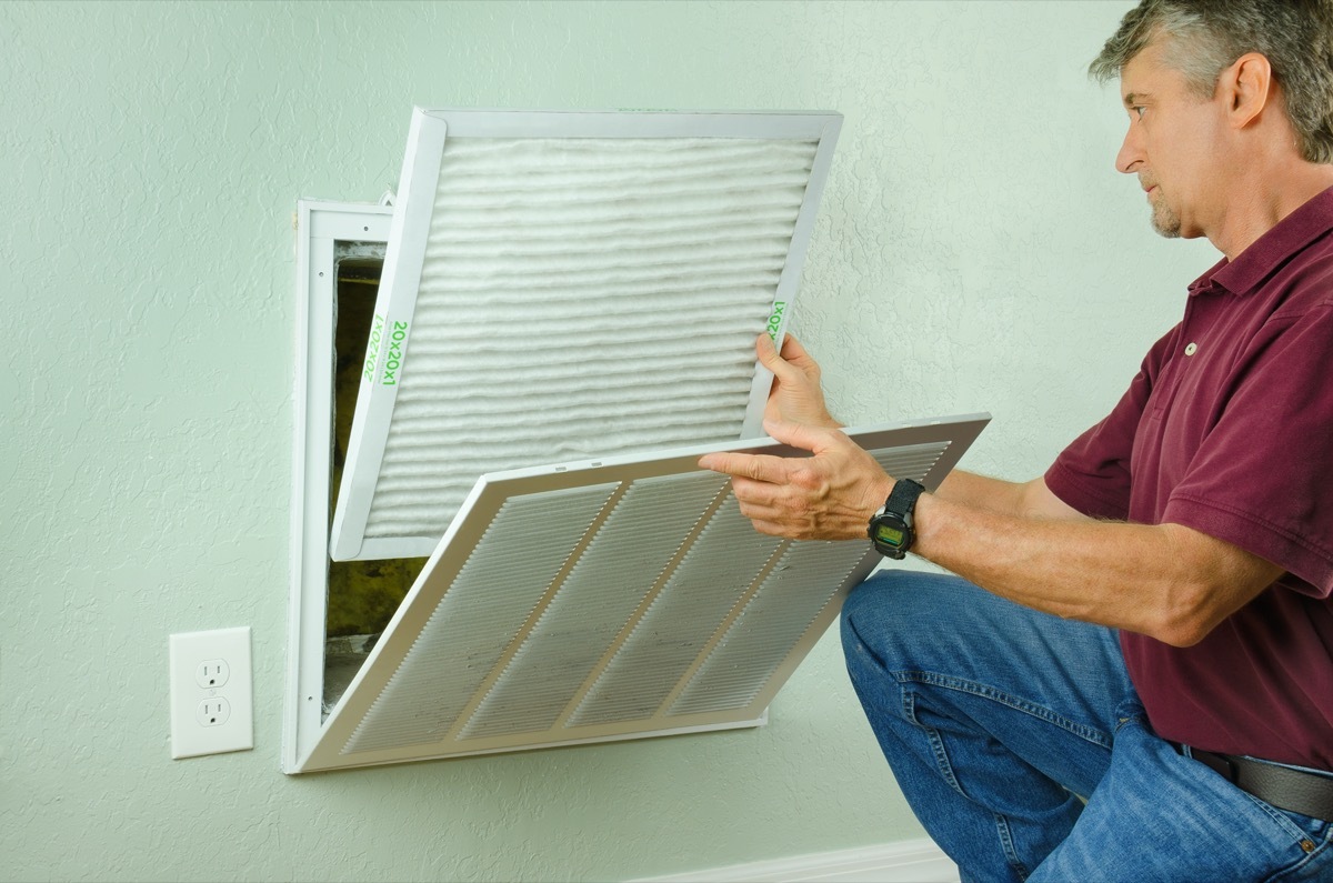 white man removing hvac filter