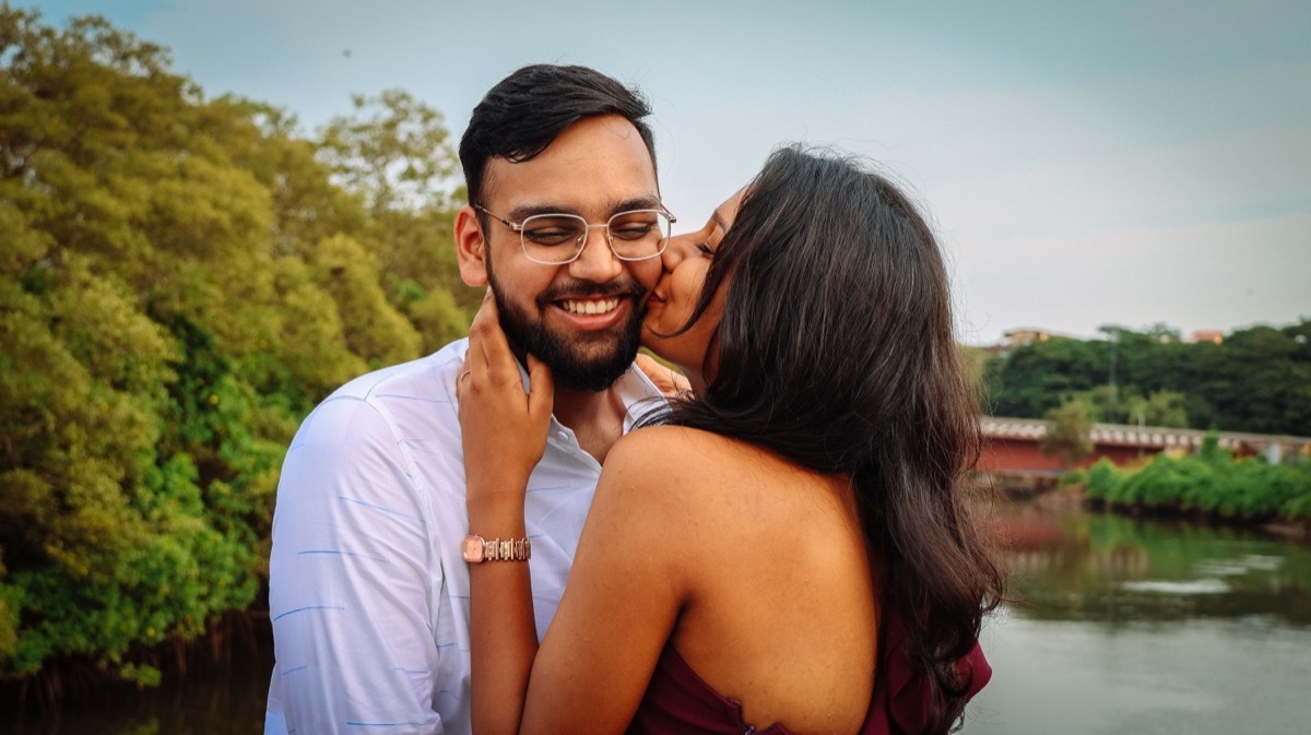 Girl Kissing Boyfriend on the Cheek