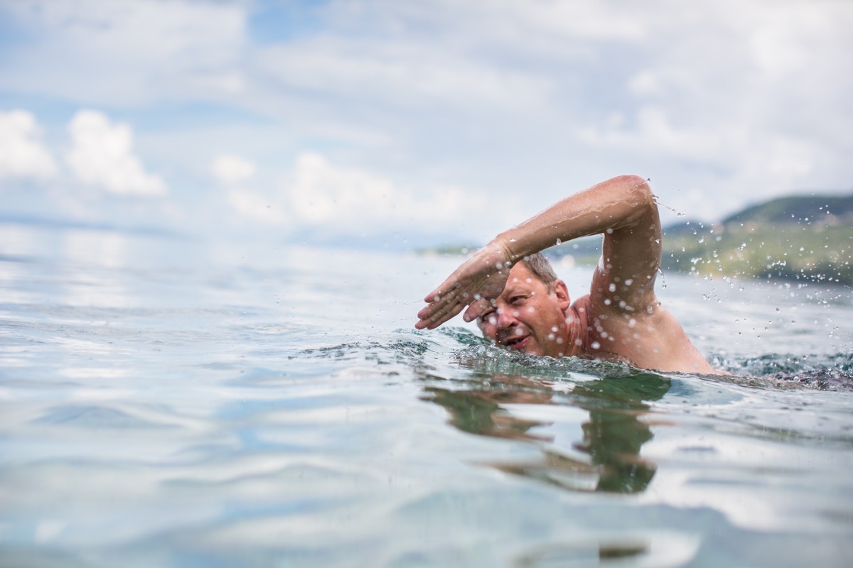 Older man swimming in ocean