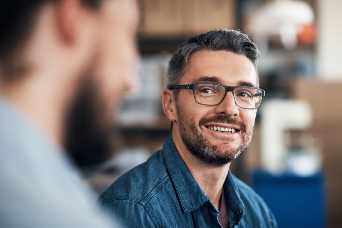 man smiling and flirting with another man